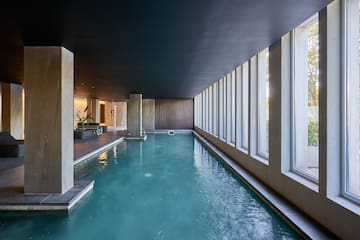 a indoor pool with large windows