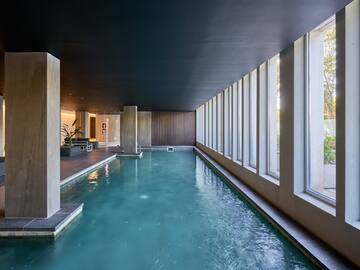 a indoor pool with large windows