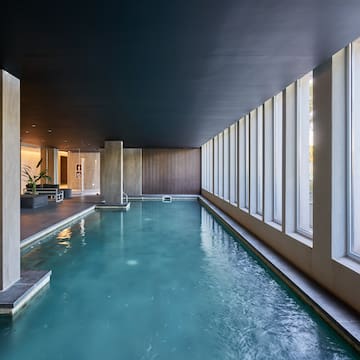 a indoor pool with large windows