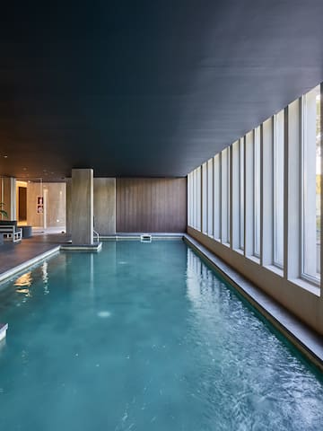 a indoor pool with large windows