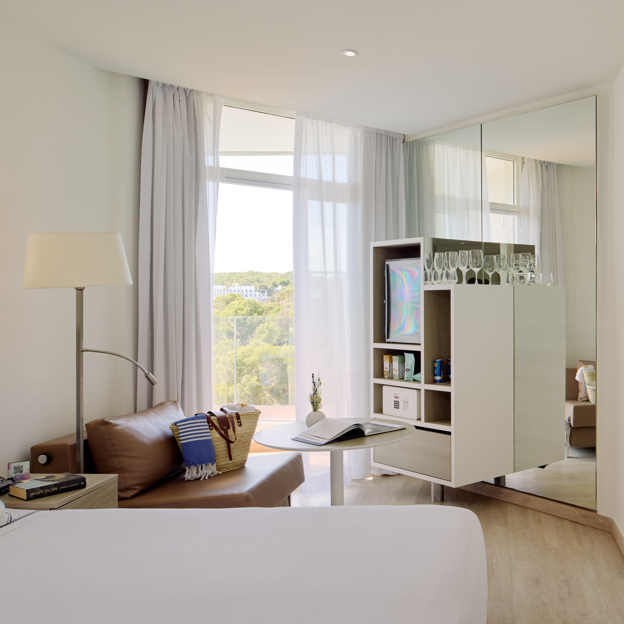 a room with a bed and a table and a mirror