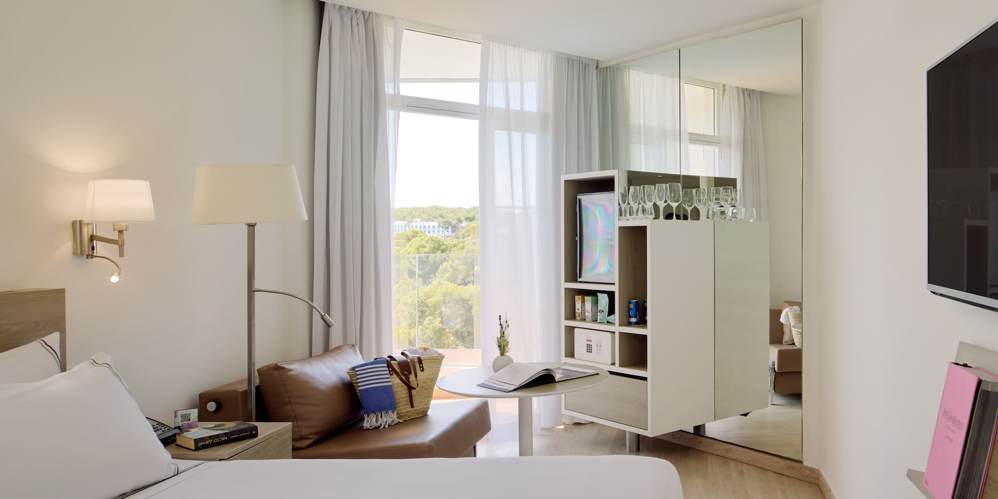 a room with a bed and a table and a mirror