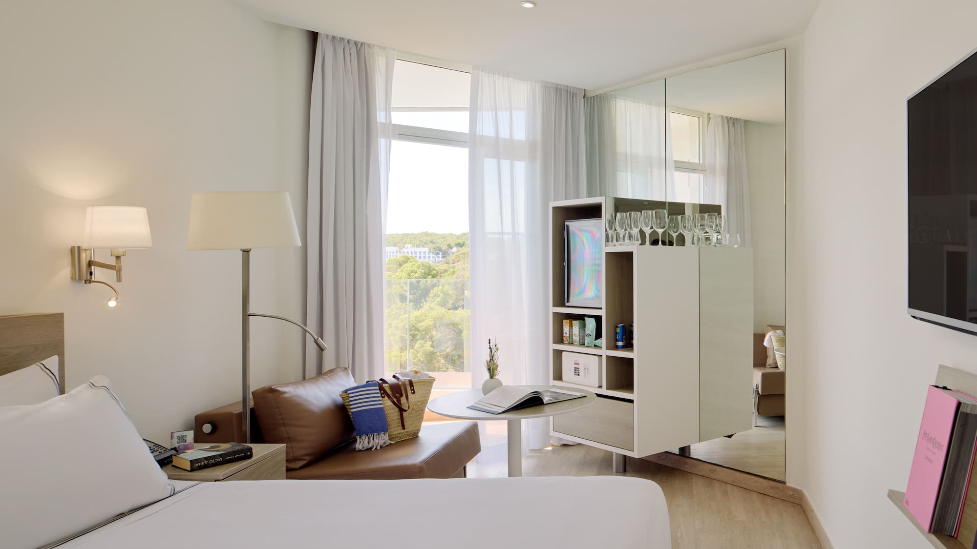 a room with a bed and a table and a mirror