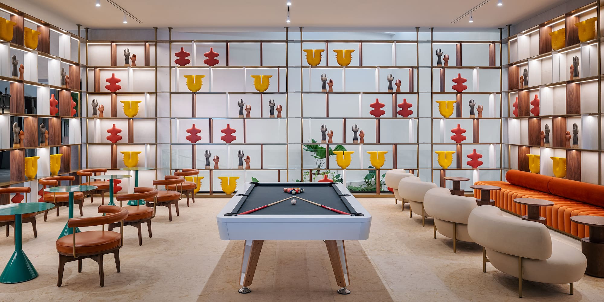 a pool table in a room with chairs and tables