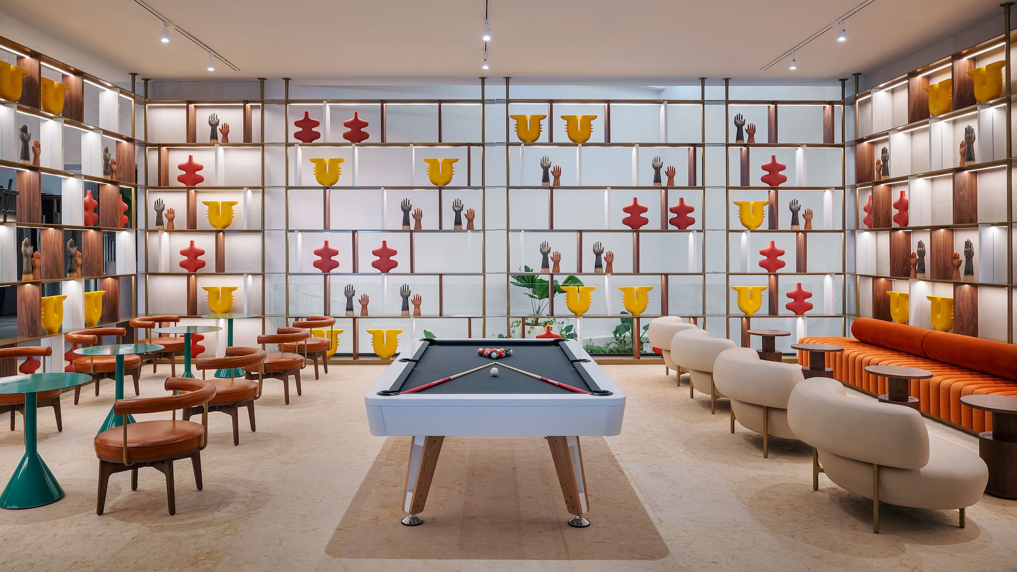 a pool table in a room with chairs and tables