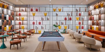 a pool table in a room with chairs and tables