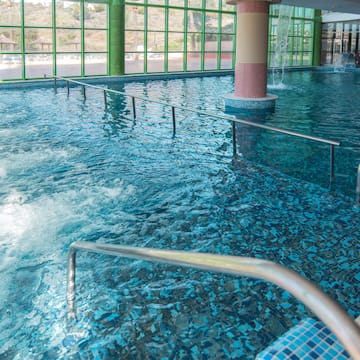 a large indoor pool with stairs and railings