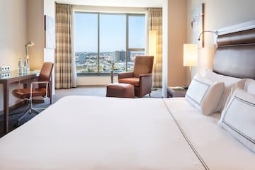 a hotel room with a large window and a bed