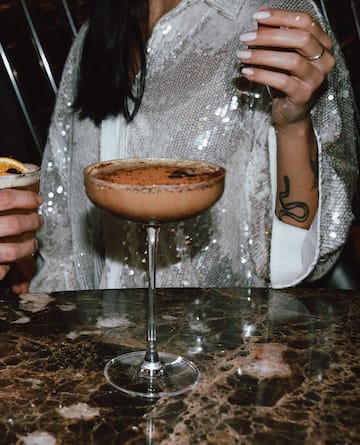 a woman holding a drink