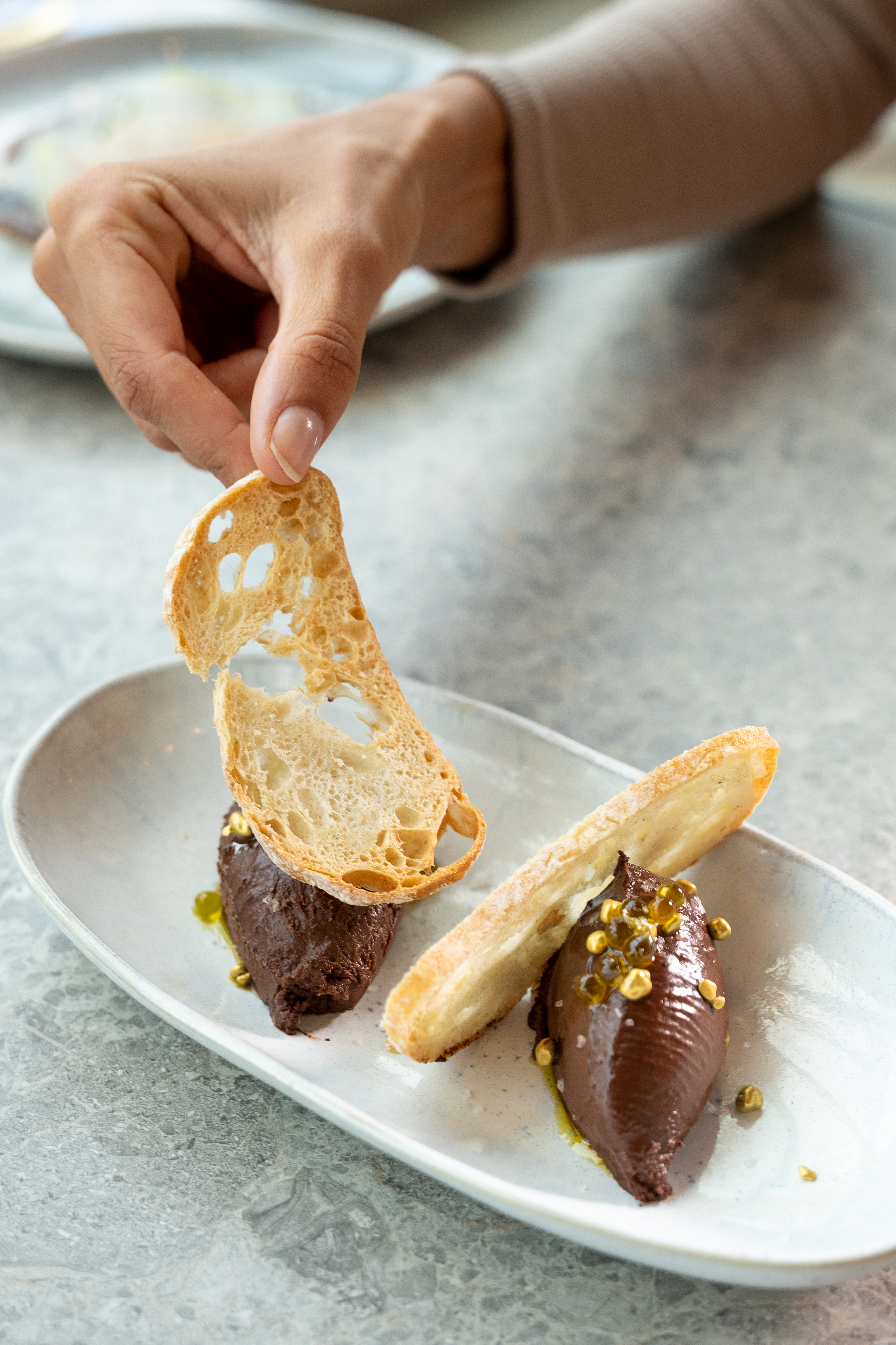 a hand holding a piece of food