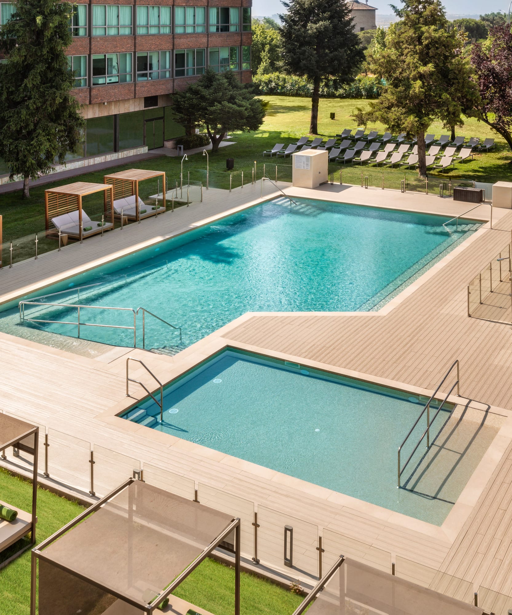 a swimming pool with lounge chairs and a building