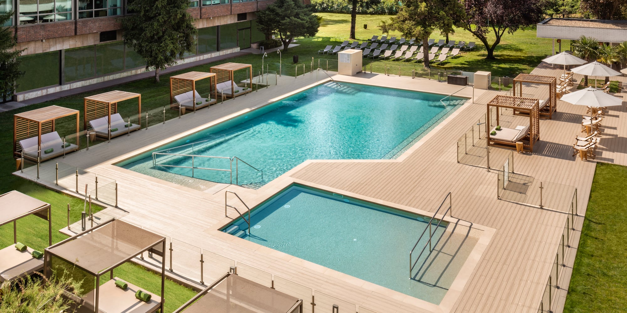 a swimming pool with lounge chairs and a building