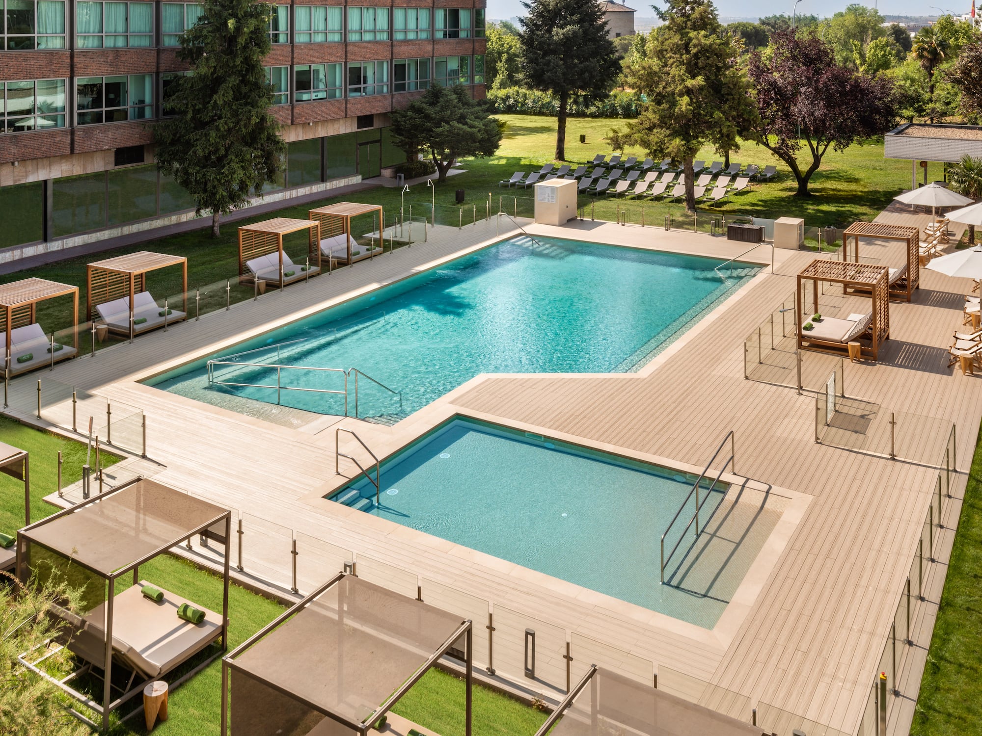 a swimming pool with lounge chairs and a building