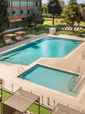 a swimming pool with lounge chairs and a building