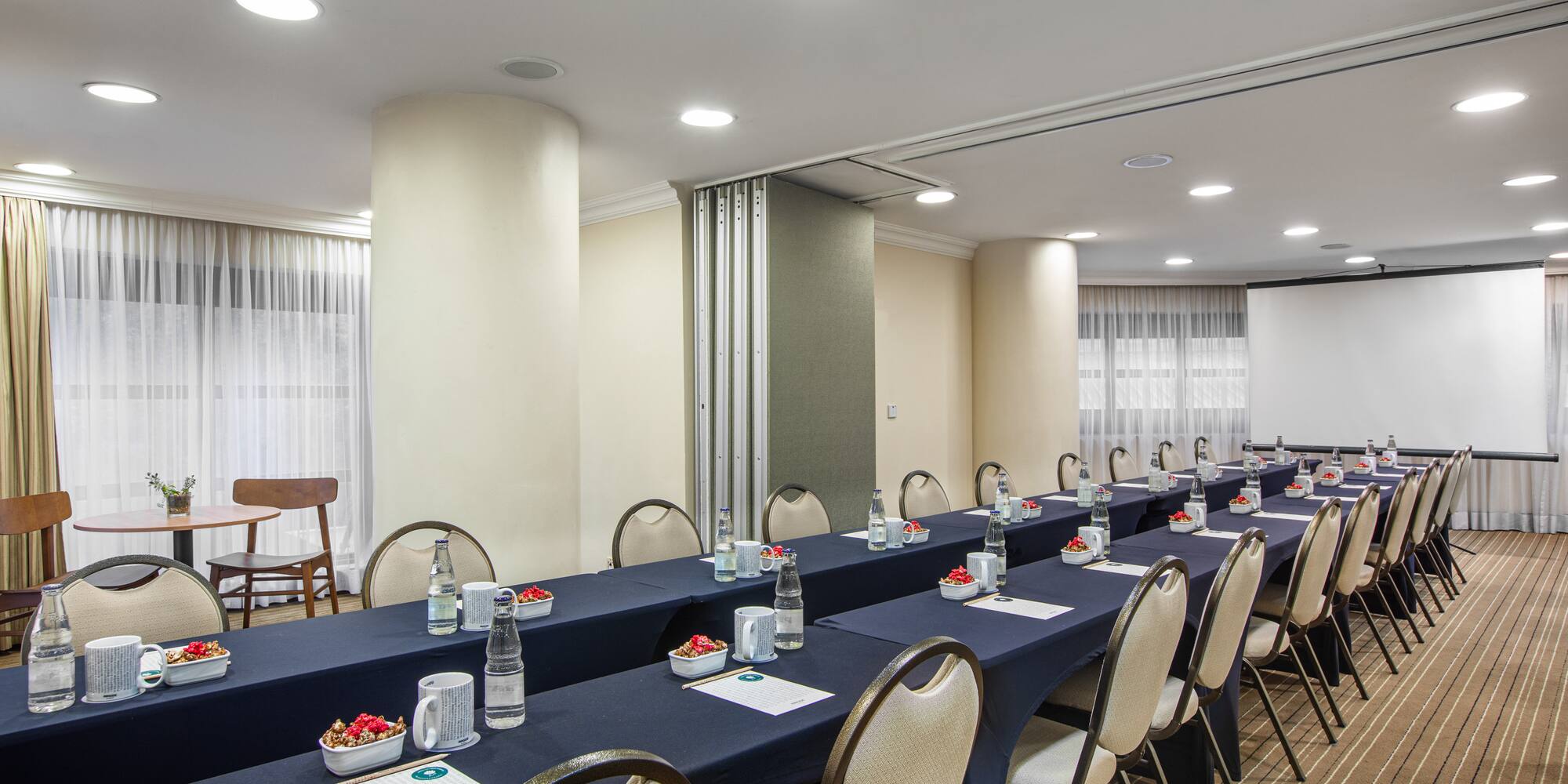 a long conference room with chairs and tables