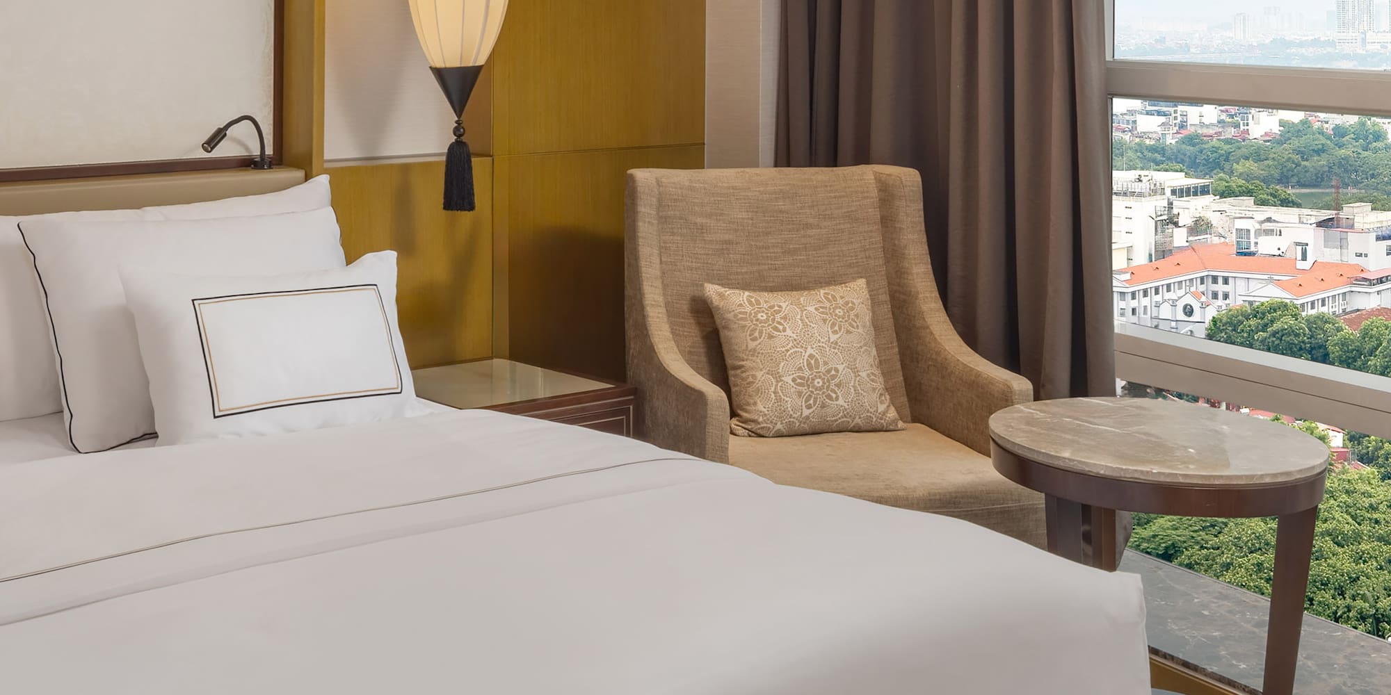 a hotel room with a bed and a chair