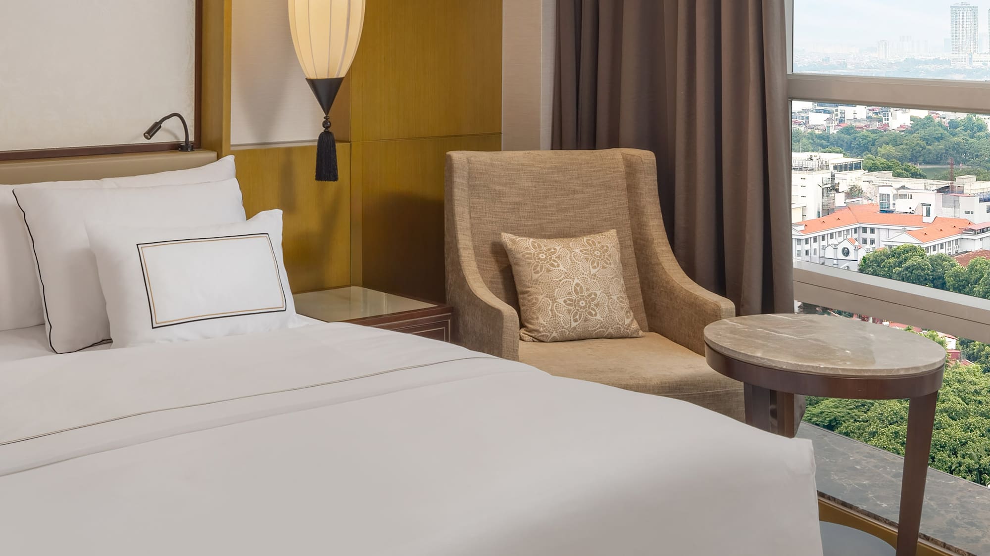 a hotel room with a bed and a chair