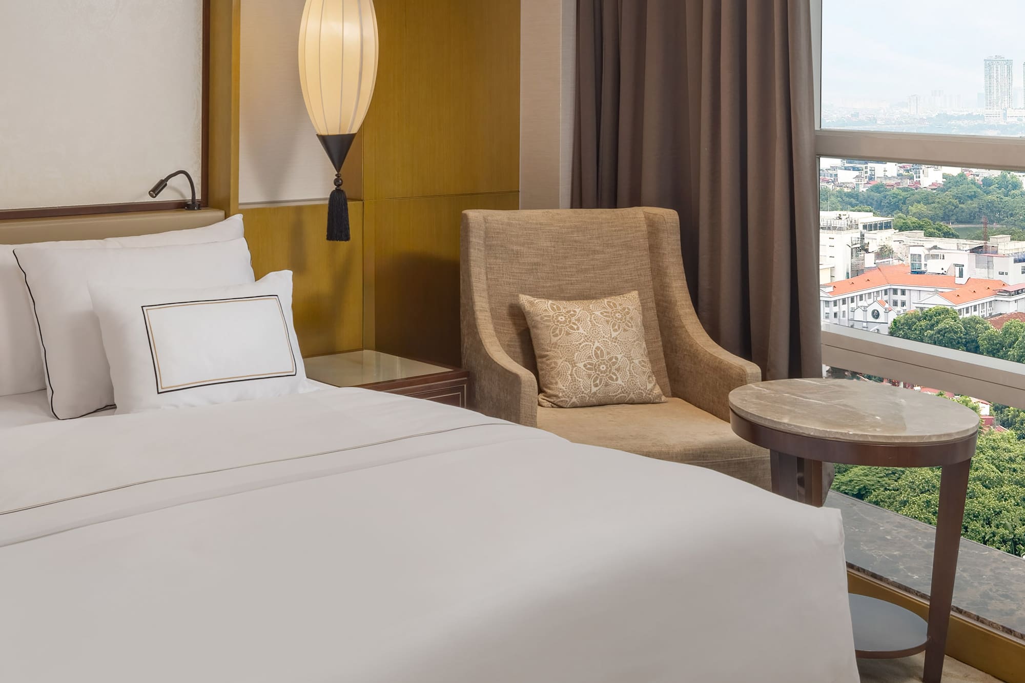 a hotel room with a bed and a chair