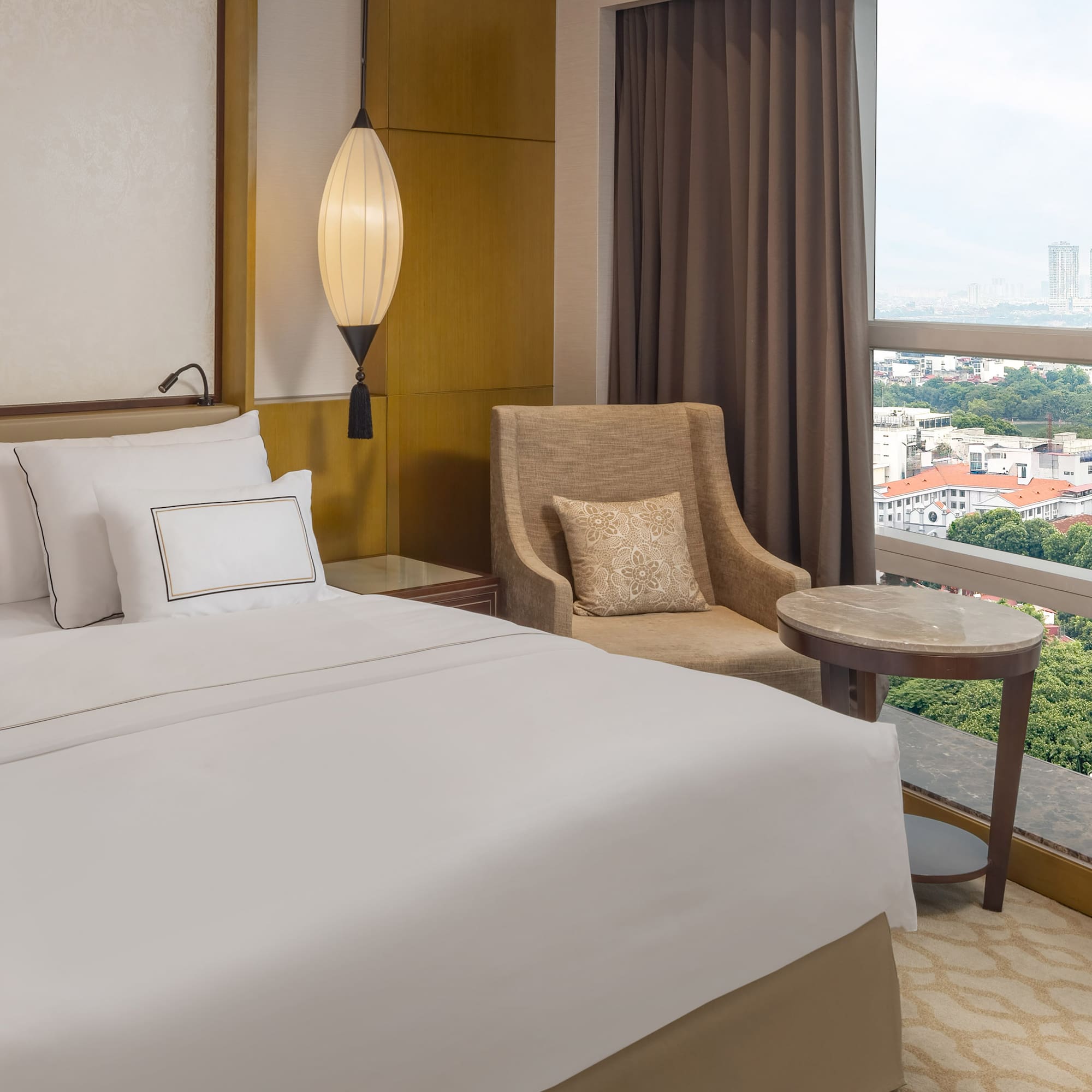 a hotel room with a bed and a chair