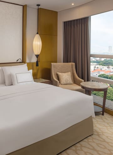 a hotel room with a bed and a chair