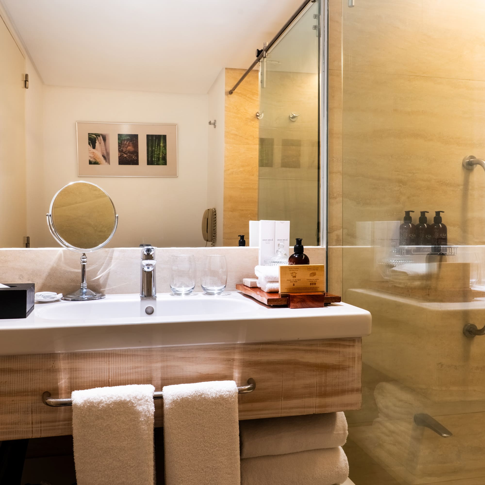 a bathroom with a glass shower and a mirror
