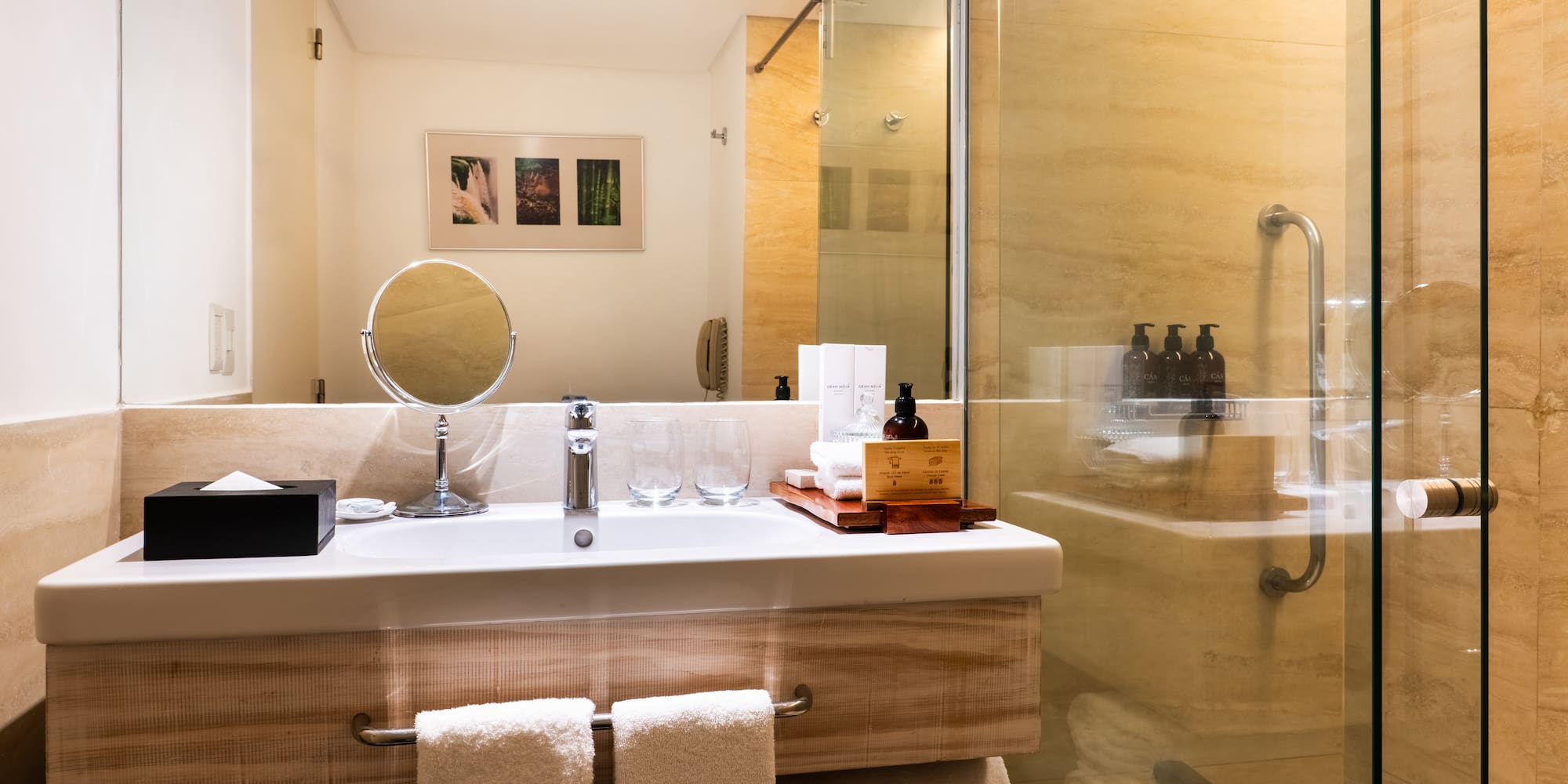 a bathroom with a glass shower and a mirror
