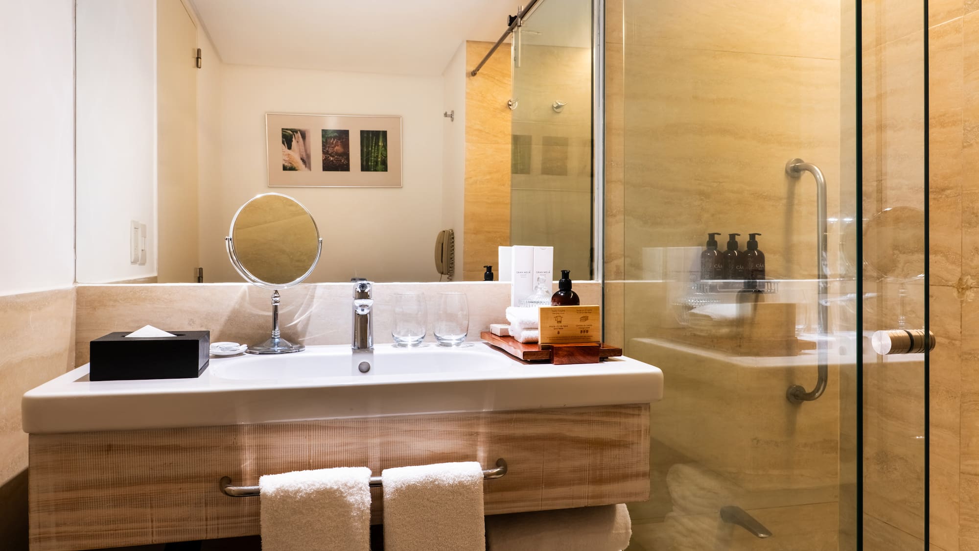 a bathroom with a glass shower and a mirror
