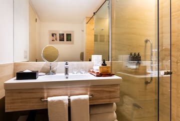 a bathroom with a glass shower and a mirror
