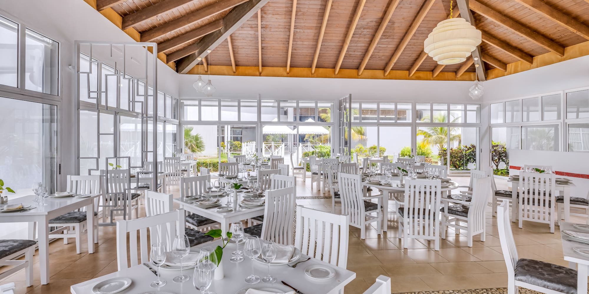 a room with white tables and chairs