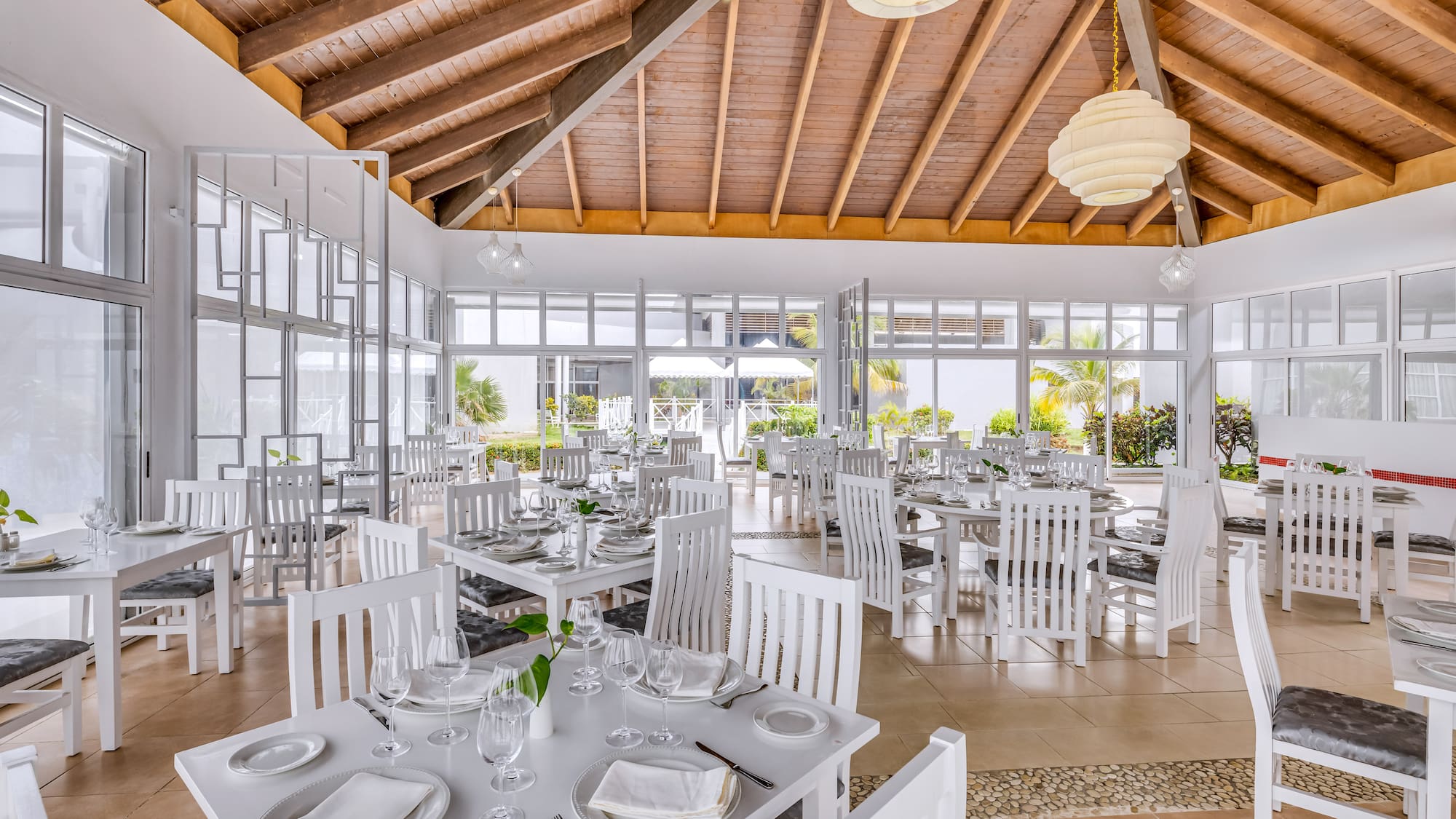 a room with white tables and chairs