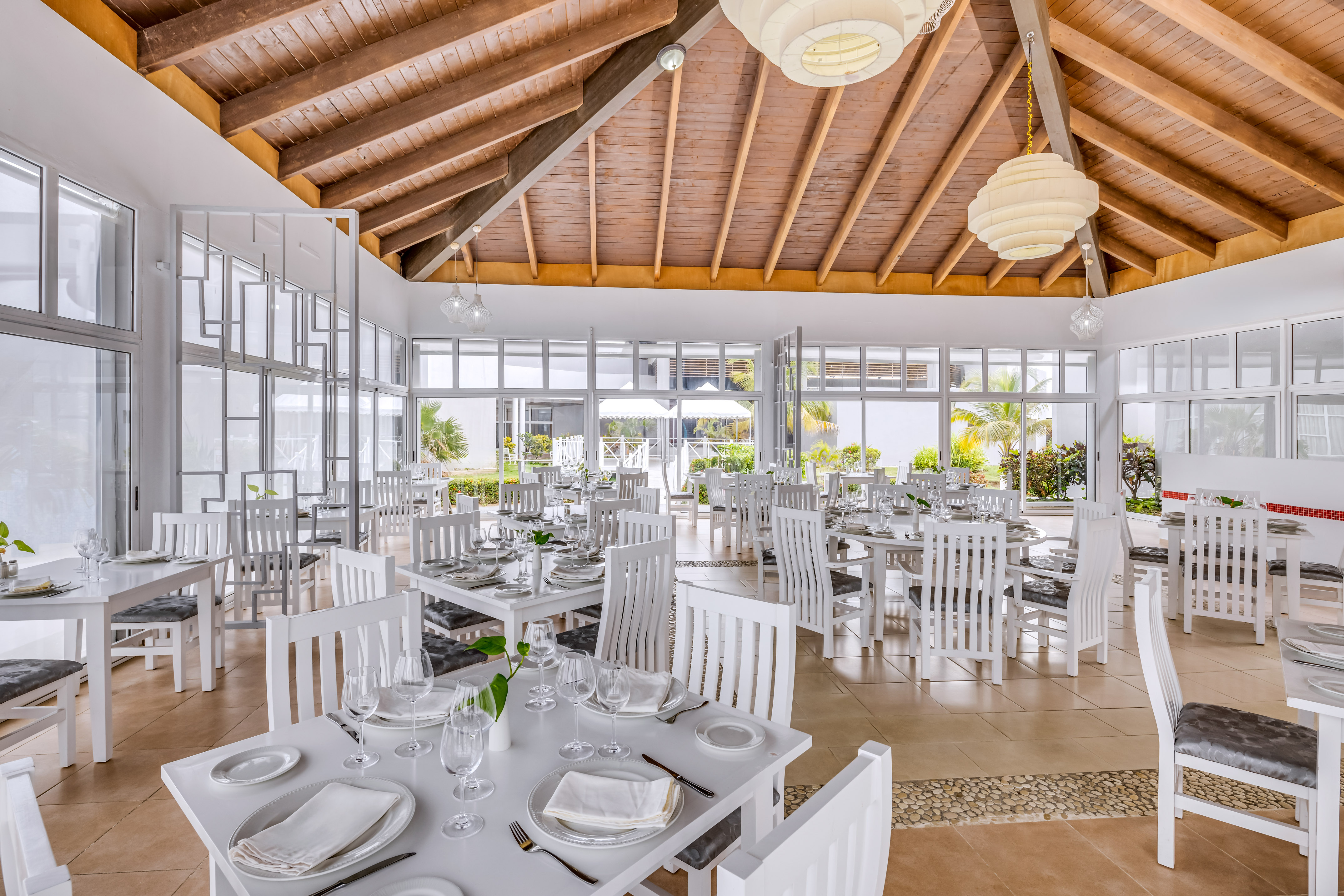 a room with white tables and chairs