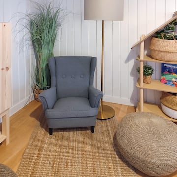 a chair and a floor lamp in a room