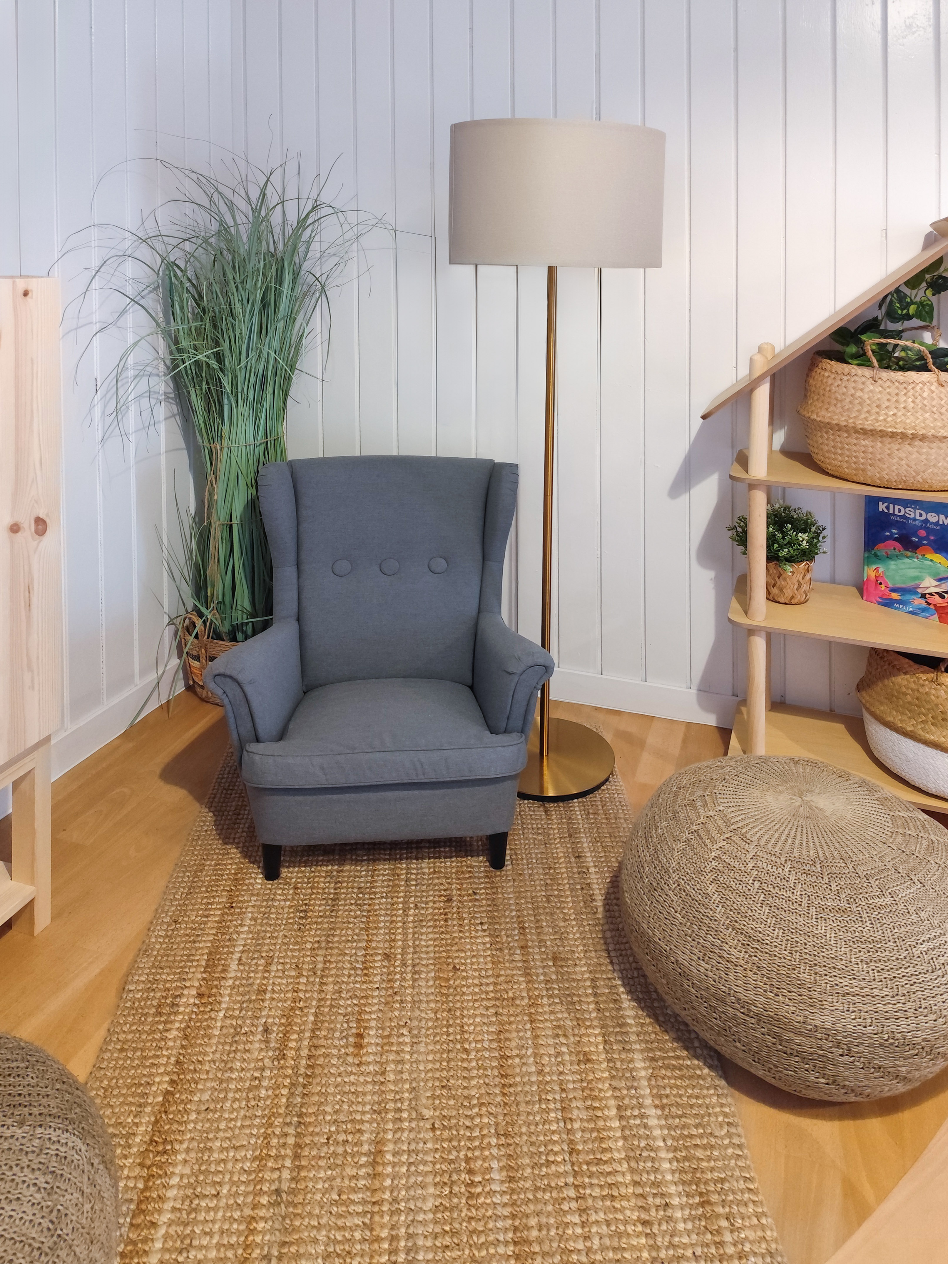 a chair and a floor lamp in a room