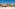 a building with palm trees and a beach