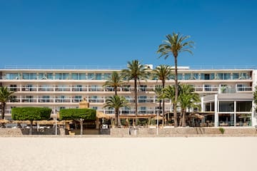 a building with palm trees and a beach