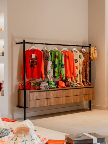 a store with shelves and clothes on swingers