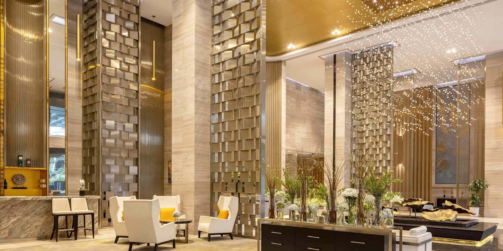 a lobby with a large group of chairs and a table