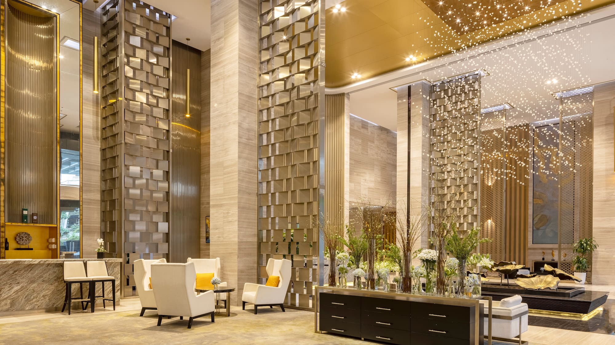 a lobby with a large group of chairs and a table