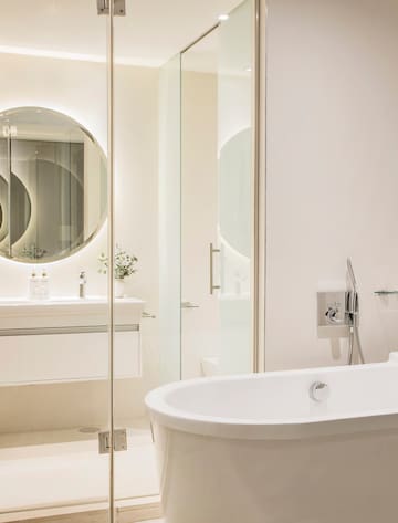 a bathroom with a tub and a mirror