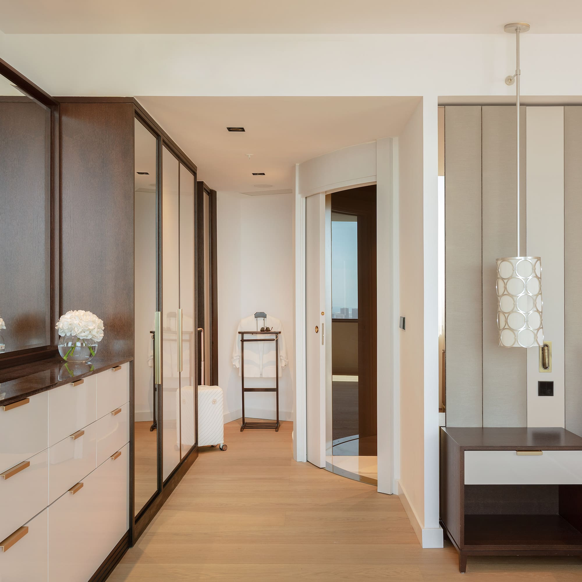 a room with a mirror and dresser