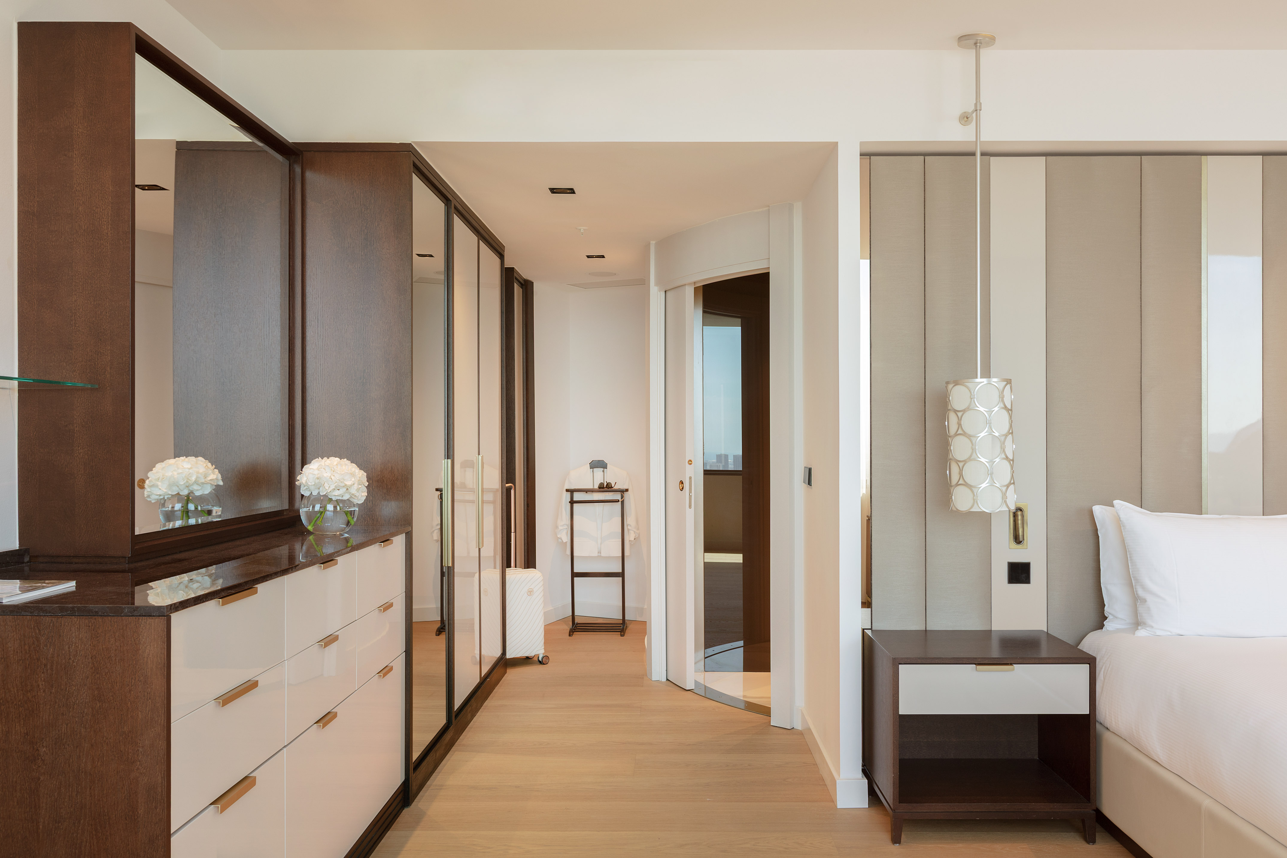 a room with a mirror and dresser