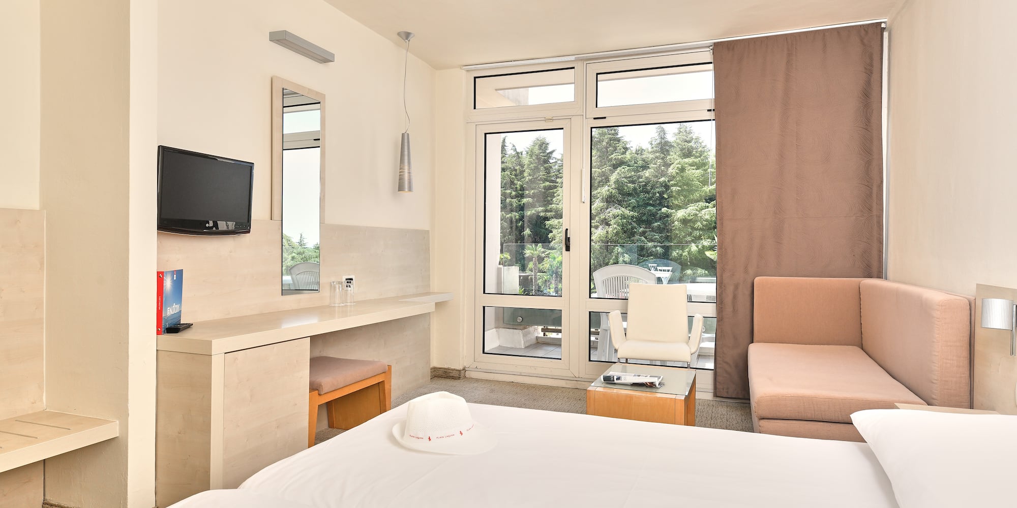 a room with a bed and a television