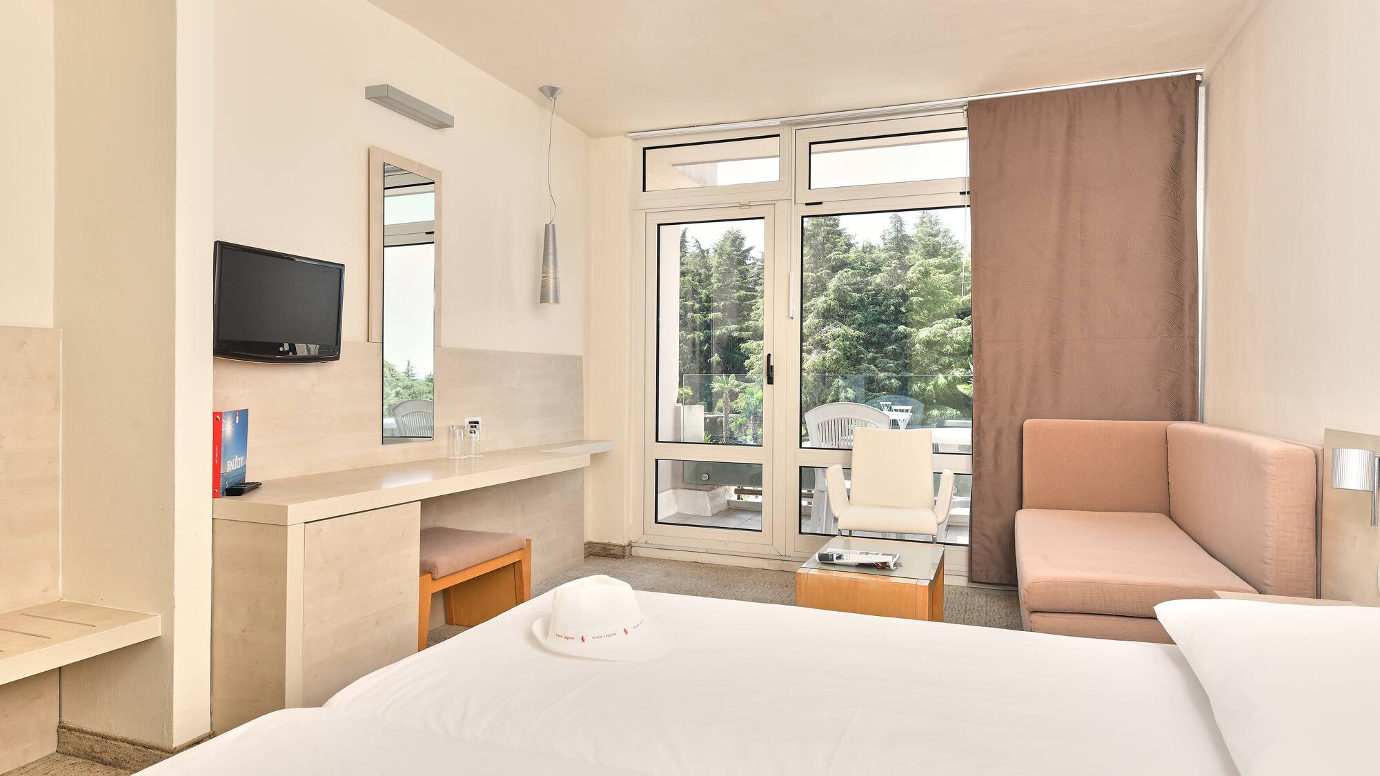 a room with a bed and a television