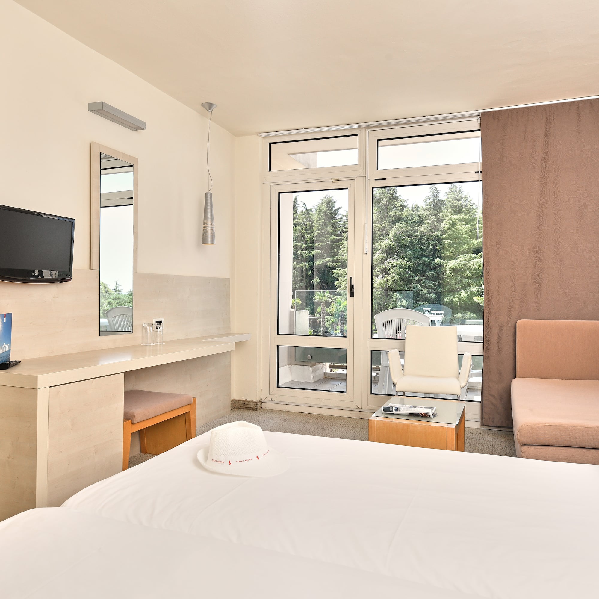 a room with a bed and a television