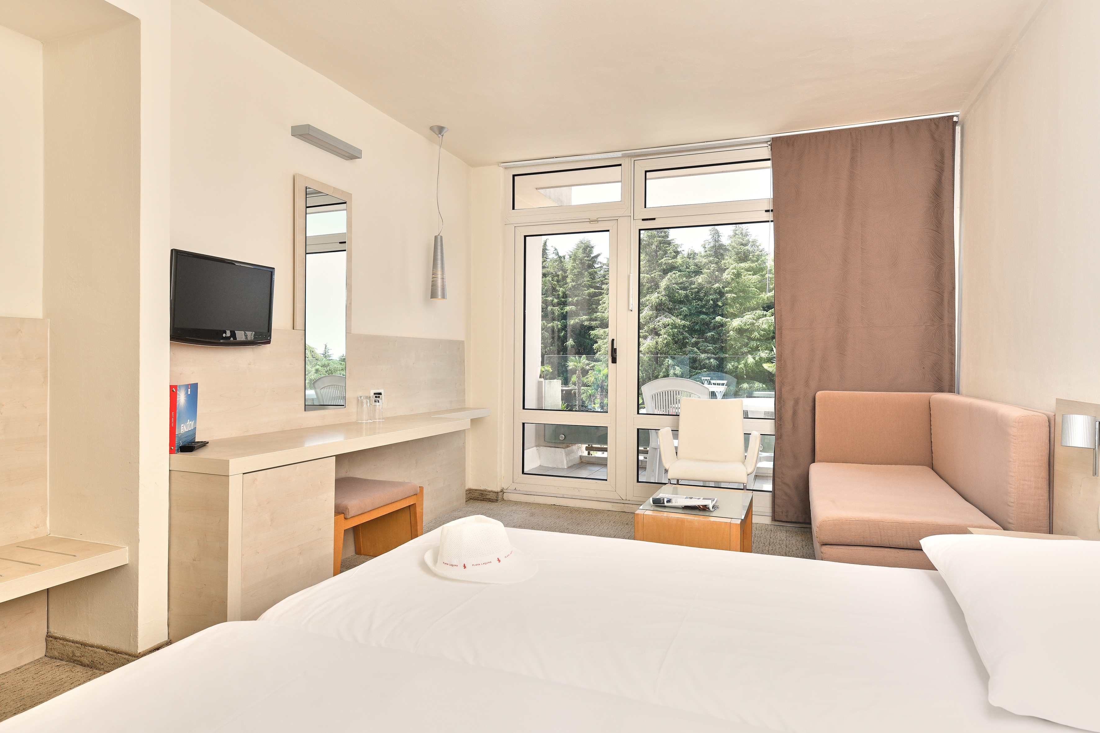 a room with a bed and a television