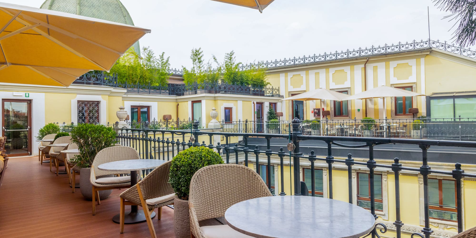 a patio with tables and chairs and umbrellas