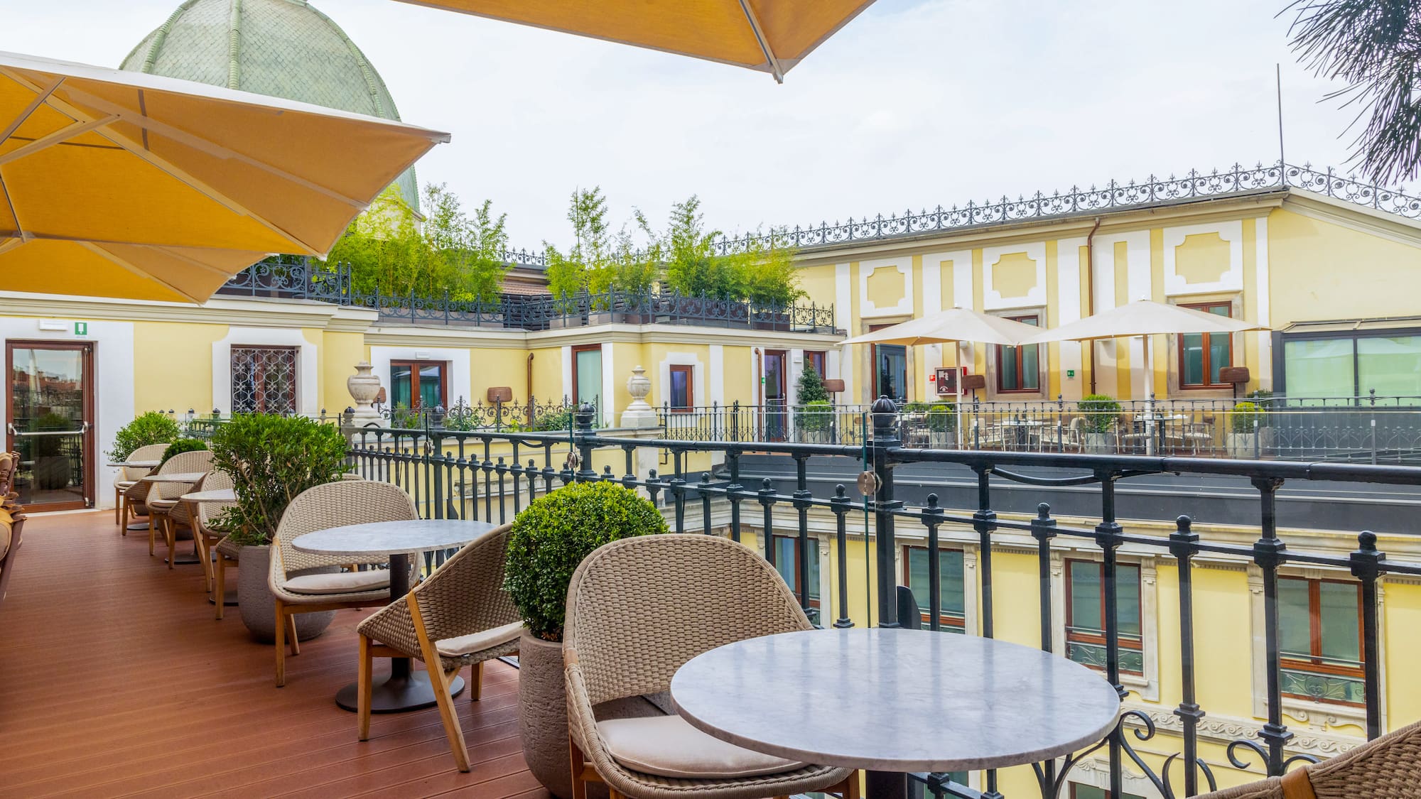 a patio with tables and chairs and umbrellas