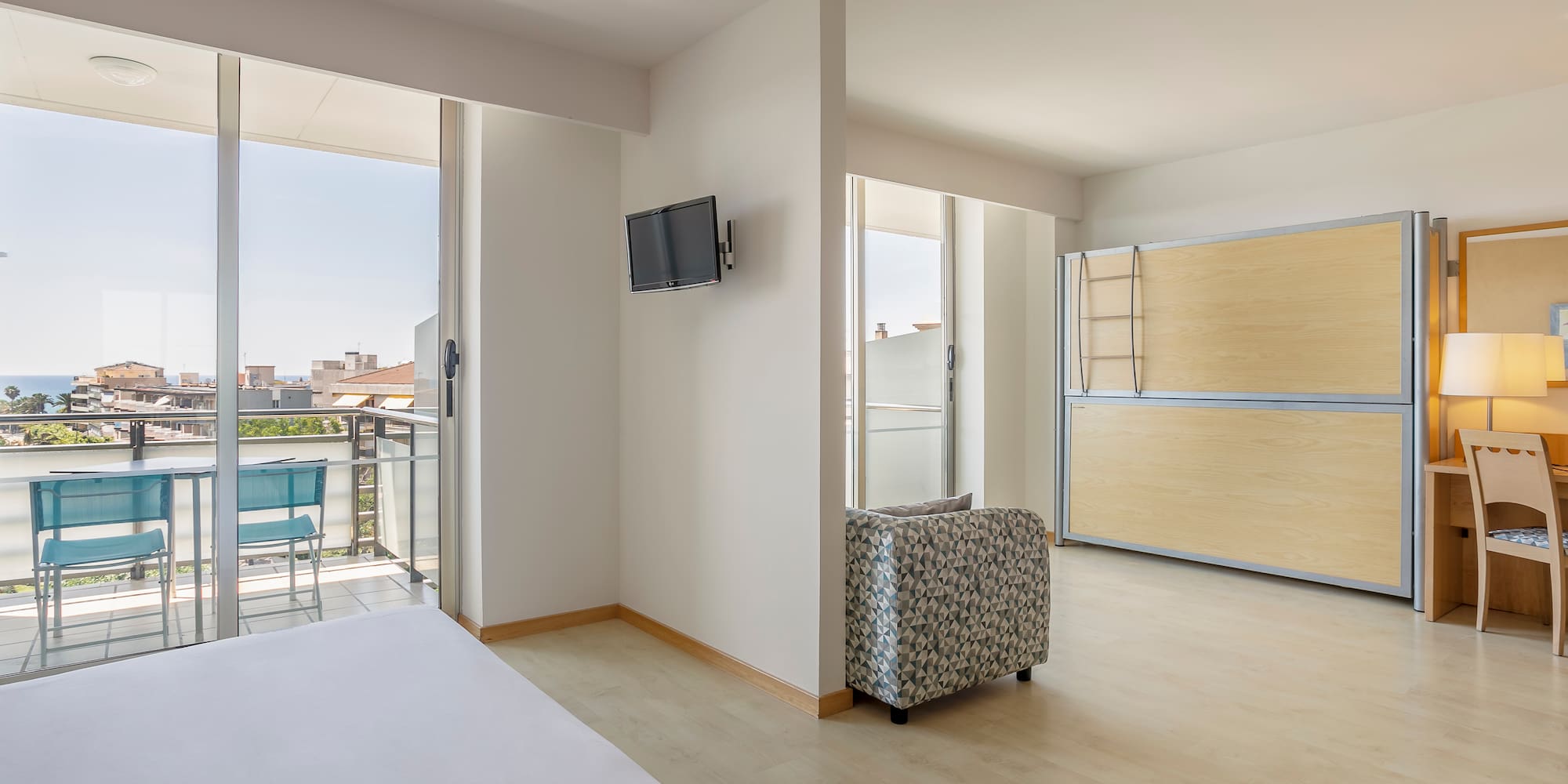 a room with a bed and a television