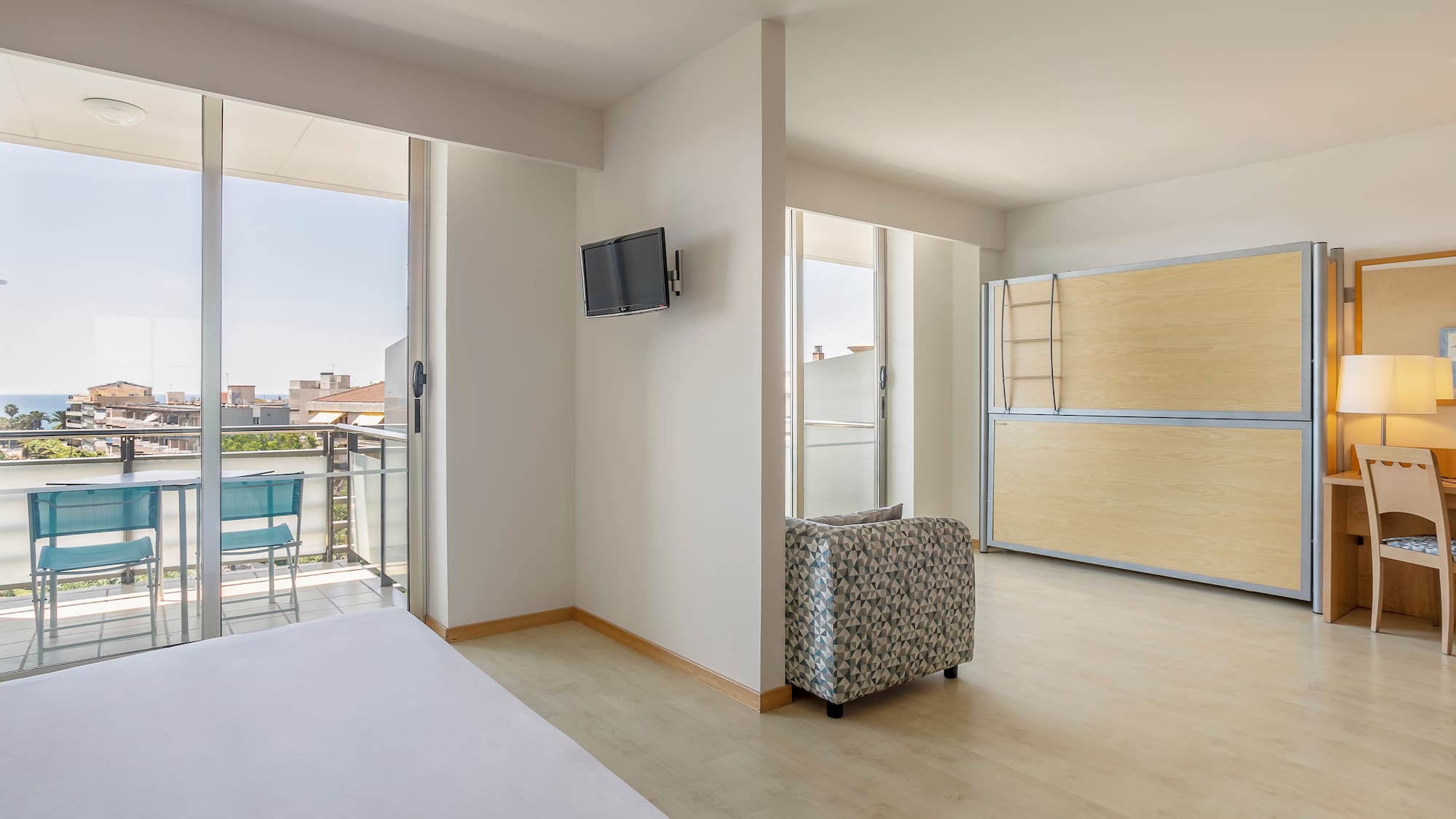 a room with a bed and a television