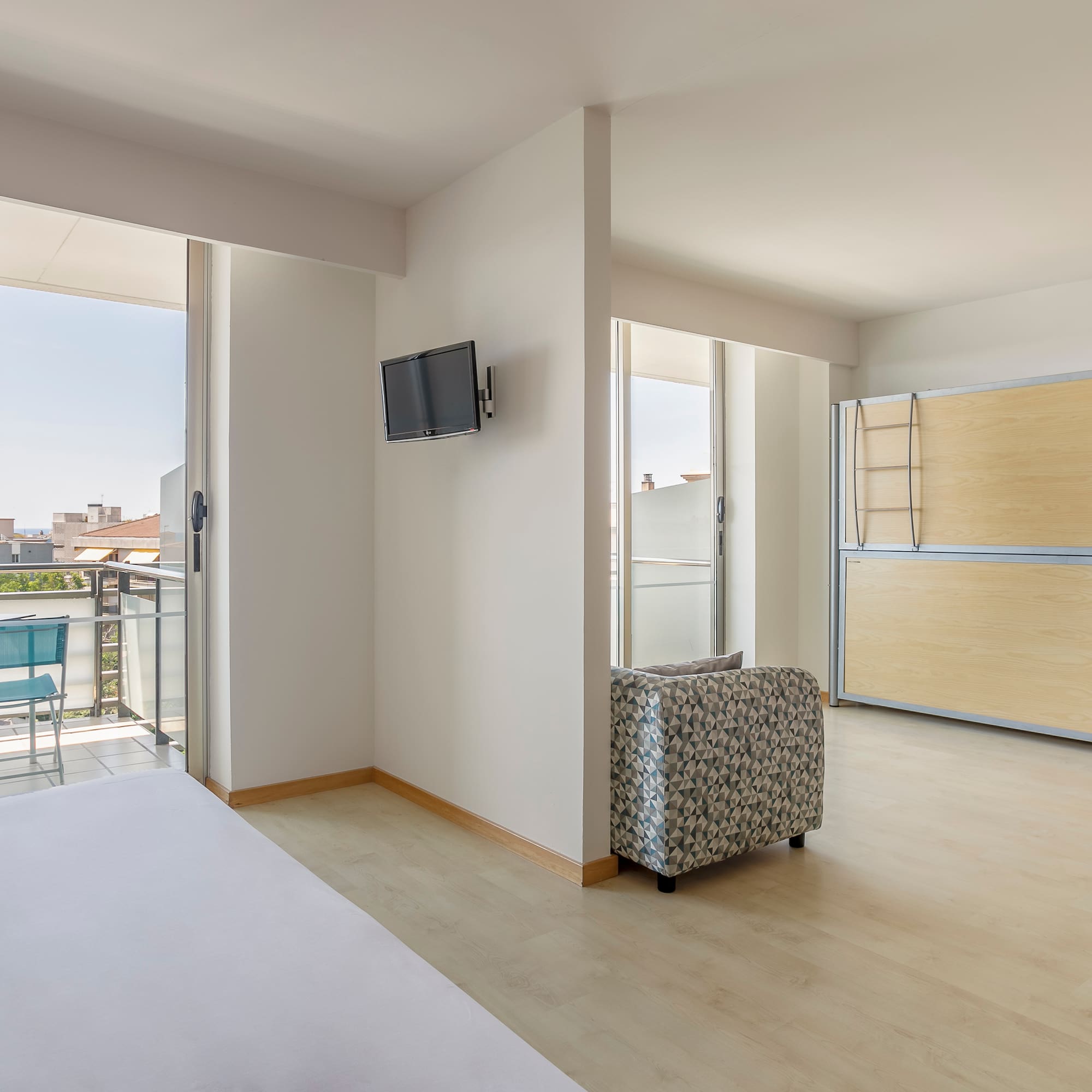 a room with a bed and a television